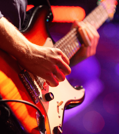 Close-up of an electric guitar being played live